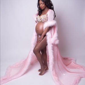 The robe. It's baby pink showing It's a girl